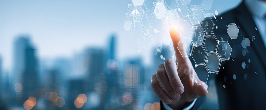 A person in a business suit interacts with a digital interface overlaid on a blurred cityscape.  A finger is touching a glowing, data-rich network of interconnected hexagonal shapes