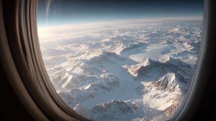 Aerial View of Snowy Mountains from Airplane Window.