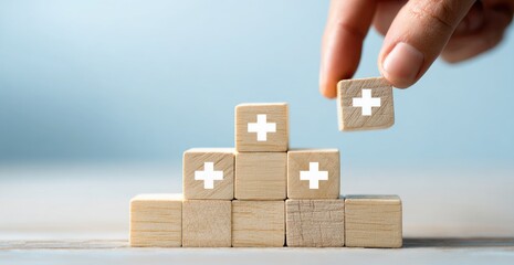 Wooden blocks forming a staircase, with plus signs, are being added to
