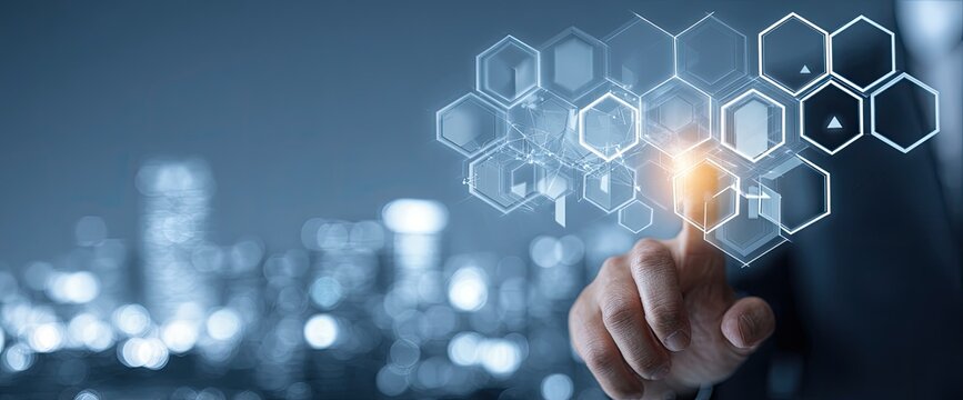A hand touches a holographic interface with hexagonal elements over a blurred cityscape - Powered by Adobe
