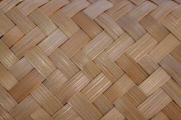 A close-up texture background of traditional woven bamboo. This neat diagonal weaving pattern showcases a classic Southeast Asian handicraft and an eco-friendly, sustainable material.