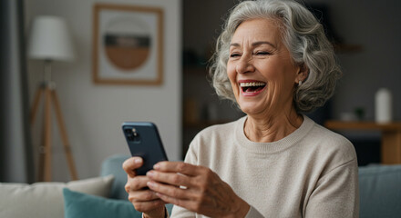 Joyful Senior Woman Laughing While Using Smartphone at Home