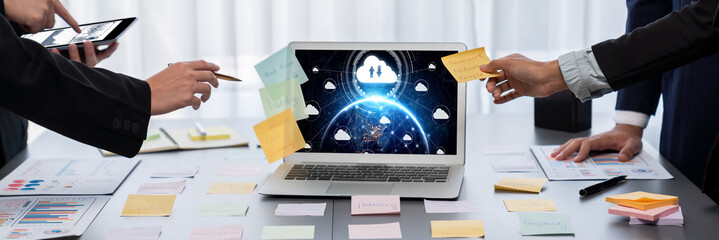 Analyst team use sticky note for creative and analytic brainstorm for business idea with BI data dashboard on laptop screen. Analysis financial data visualization tech for marketing strategy. Prodigy