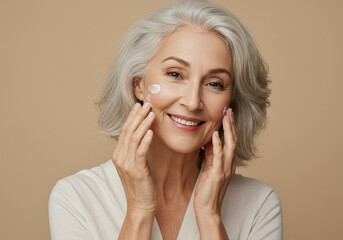 Mature woman applying facial skincare cream