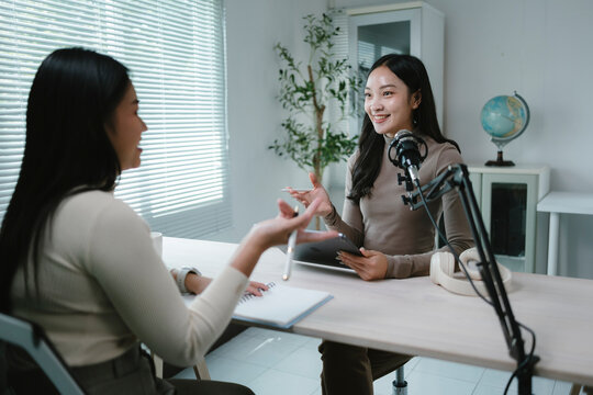 Two content creators recording podcast in home studio