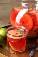 Tasty punch and fruits on wooden table, closeup. Refreshing drink