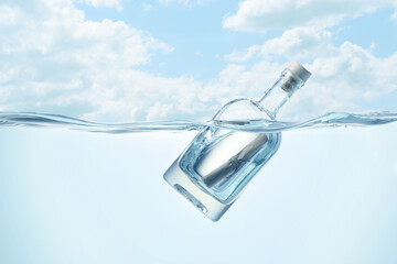 Corked bottle with rolled letter in water under sky