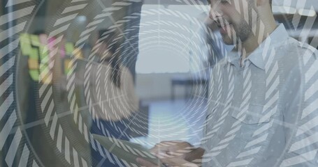 Man swiping tablet in business office, woman pointing as arrows highlighting sticky notes to plan - Powered by Adobe