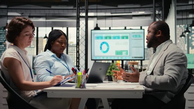 HR team conduct CV evaluation with candidate during job interview in a business space, analyzing work experience and qualifications for career development. Talent acquisition. Camera A.