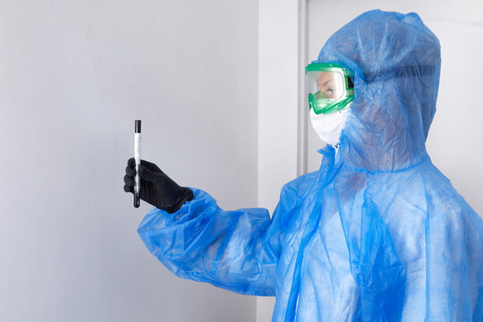 Medical healthcare technologist holding COVID-19 swab, wearing PPE protective suit, mask, gloves. Test tube for taking OP NP patient specimen sample, PCR DNA testing protocol process