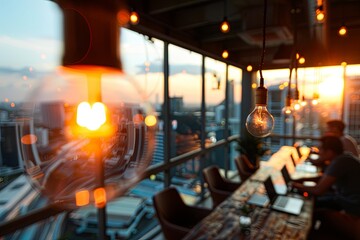 Two adults focus on laptops in a modern office space. Warm ambient light from sunset creates a relaxed and productive atmosphere.