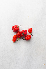 Overhead view of scotch bonnet pepper on a white countertop, top view of habanero type pepper, top view of nigerian atarodo pepper