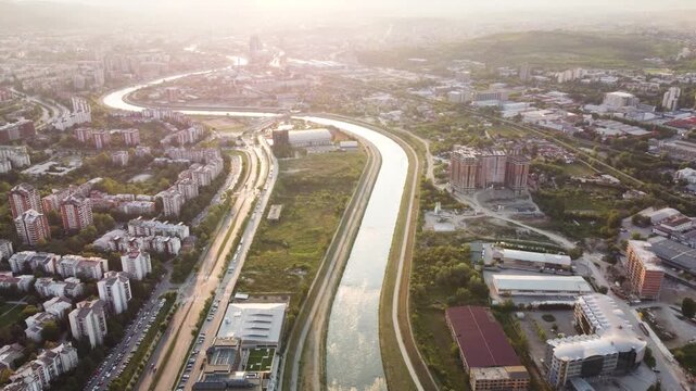 Aerial Panorama of the Vardar River Winding Through Skopje City at Sunset, North Macedonia