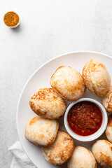 Overhead view of a plate of masa and pepper sauce, top view of food from northern nigeria masa rice cake and stew, nigerian ethnic foods