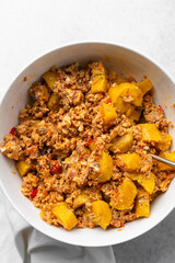 overhead view of Boiled ripe plantain with tomato scrambled eggs in a white bowl, top view of nigerian egg and plantain