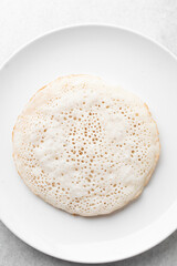 Overhead view of a plate of sinasir, top view of food from northern nigeria sinasir rice pancake, nigerian ethnic foods