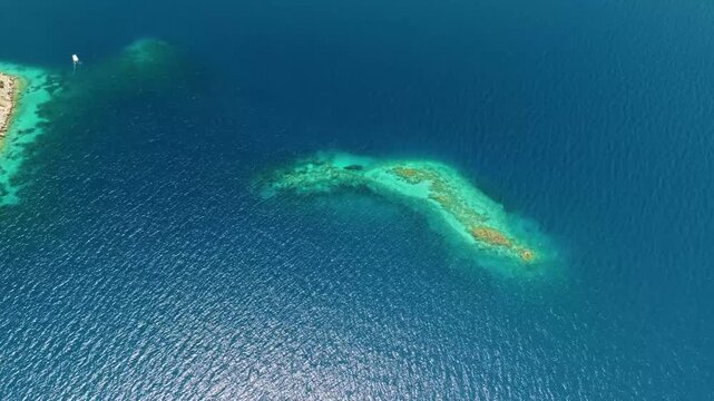 Drone footage captures the breathtaking aerial perspective of Cennet Koyu, also known as Paradise Bay, on the stunning Mediterranean coast of Turkey.