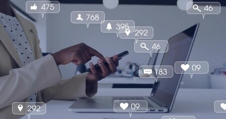 Digital marketer scrolling smartphone and tracking animated engagement icons floating around laptop - Powered by Adobe