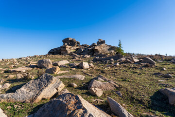 The strange rocks on the mountain are under the blue sky