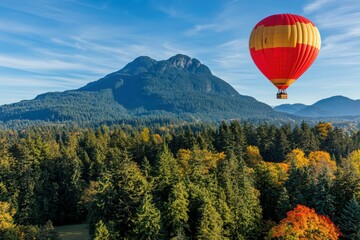 Fototapeta premium Colorful Hot Air Balloon Over Scenic Mountain Landscape