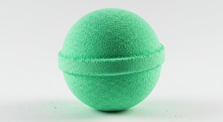 A single green bath bomb sits on a white background.