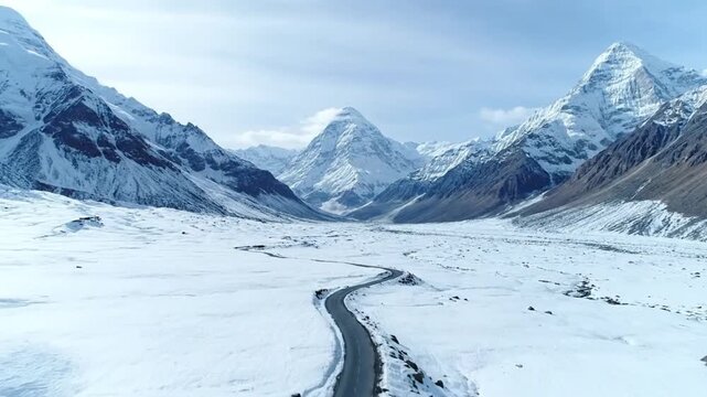 Aerial Drone View of Himalayan Roads Cutting Through Snowy Mountain Terrain
