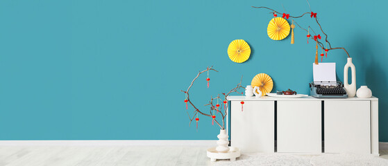 Interior of room with commode, typewriter and decor for Chinese New Year celebration