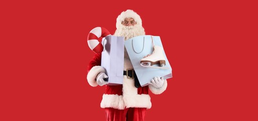 Santa Claus with shopping bags, ice skates and toy candy cane on red background