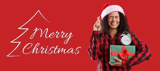 Christmas banner with happy African-American woman holding gift with alarm clock and making wish on...