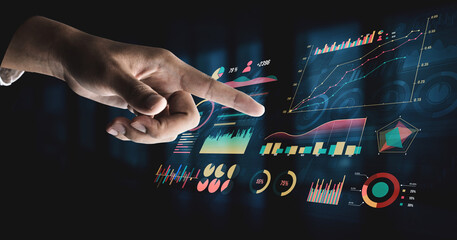 A professional hand interacts with a futuristic data display, showcasing dynamic graphs and charts for business analysis and decision-making. Impute