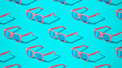 Bright pink Wayfarer sunglasses, blue lenses, repeating pattern, turquoise background