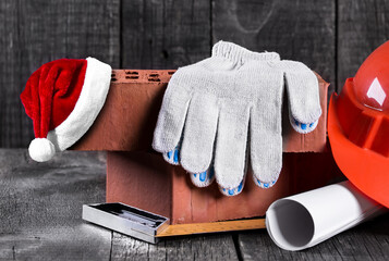 Santa Claus hat on construction tools closeup on wooden background. Christmas and New Year celebration