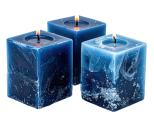 Three lit, square candles in varying shades of blue, with textured wax