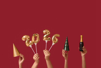 Female hands with champagne bottle and figure 2024 made of balloons on red background