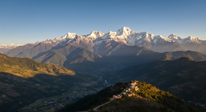 Majestic mountain range with snow capped peaks under clear blue sky