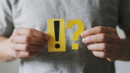 Person holding yellow exclamation and question marks