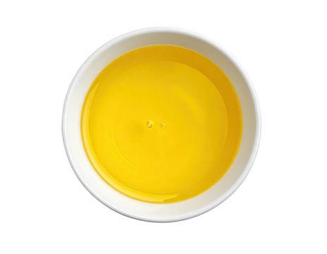 Overhead shot of a small white bowl filled with bright yellow liquid