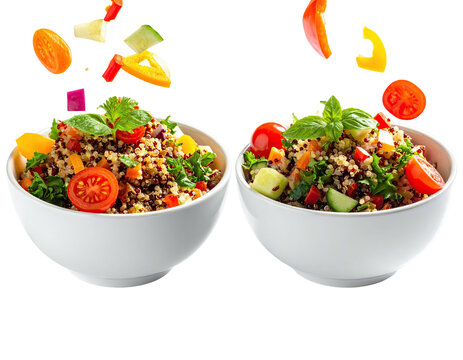 Two bowls of quinoa salad with fresh vegetables, ingredients floating