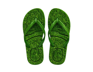 Two green flip-flops textured to resemble grass, on a black background