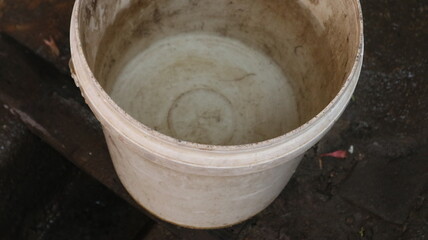 Fototapeta premium An empty bucket filled with white paint. Usually used to fill clean water or other needs. You could say this is a recycling tool.