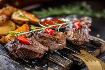 Closeup of grilled beef steak with rosemary and chili