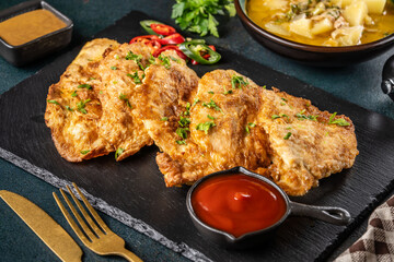 Schnitzel in egg batter with sauces and garnish