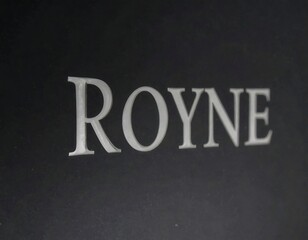 Close-up view of a dark gray surface with embossed white text