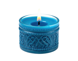 Lit blue candle with ornate Celtic knotwork carvings on its cylindrical base