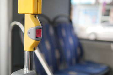 Button to request a stop on a city bus interior