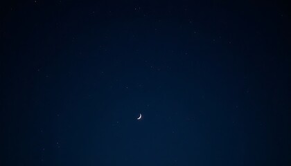 Fototapeta premium Crescent Moon and Scattered Stars Illuminating a Deep Night Sky