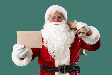 Santa Claus with Christmas bag and letter on green background