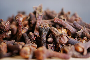 Cloves stacked together in a close-up view with rich texture