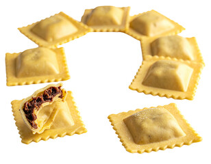 Several fresh, square pasta shapes arranged in a circle, one cut open showing filling