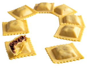 Several fresh, square pasta shapes arranged in a circle, one cut open showing filling